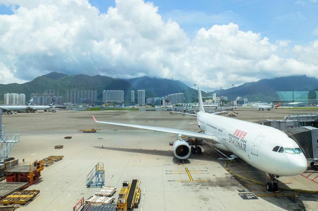 A plane on a tarmac with mountains in the background